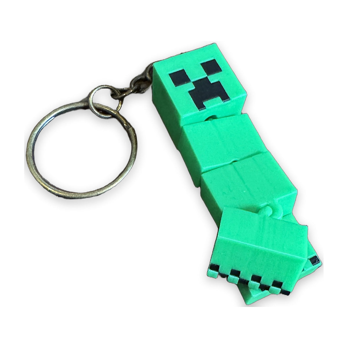 Creeper keychain seen from the side, legs bent