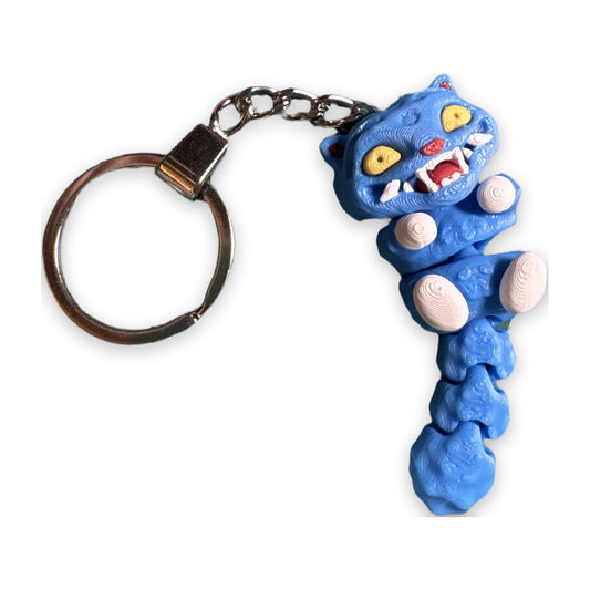 Articulated blue demon cat keychain with yellow eyes